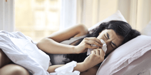 Woman sneezing with seasonal allergies