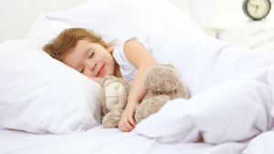 Child sleeping in comfortable bedding